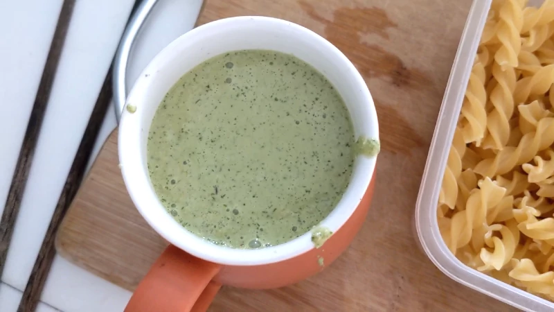 green pesto sauce in a cup